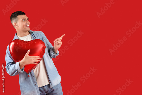 Smiling young man holding r...
