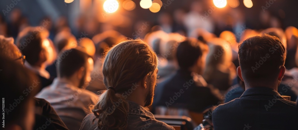 Audience seen from behind at a business meeting