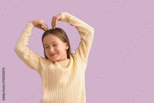 Happy little girl making he...