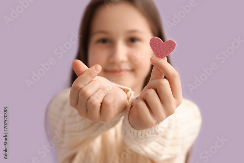 Cute little girl making hea...