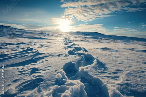 A pristine snowfield with a single set of footprints leading to a heart shape, a pure and untouched space for loving thoughts copy-space photo