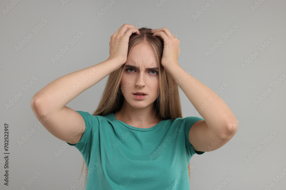 Portrait of resentful woman on grey background Portrait of resentful woman on grey background
