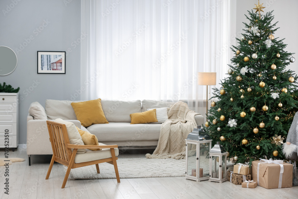 Fototapeta premium Christmas tree in furnished living room. Festive interior design