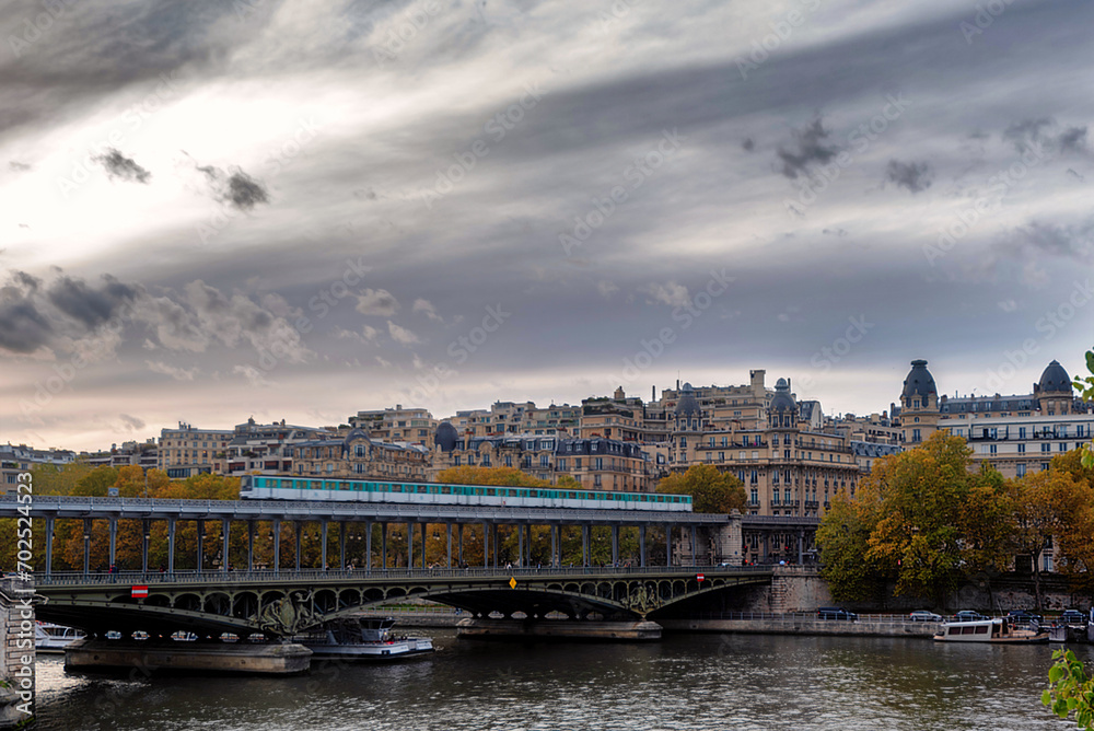 Paris metro train crossing the Bir Hakeim Bridge in Paris, France on a cloudy day