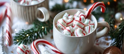 Candy canes in white setting with peppermint hot chocolate.