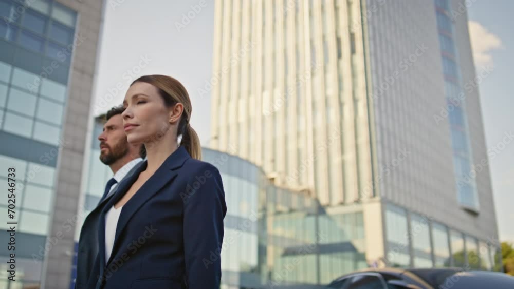 Two businesspeople walking urban district in elegant formal suits close up. Two businesspeople walking urban district in elegant formal suits close up.