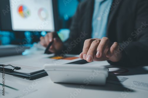 They are having a meeting about the company's income and expenses, team of analyst working on financial data analysis dashboard on paper as marketing indication for business strategic planning.