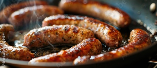 Italian sausage links sizzling in a pan. photo