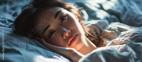 Asian woman waking up in bed, looking beautiful