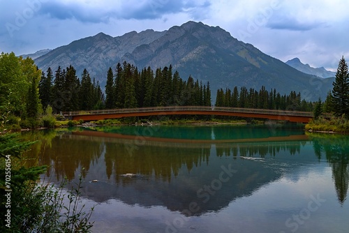 Moody Mountain Reflections On The Banff Bow River