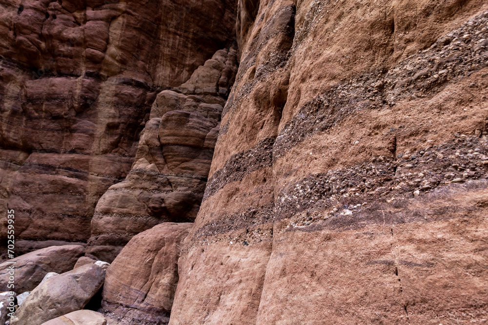 Bizarre natural stripes on rock walls along a shallow stream along the Wadi Numeira hiking trail in Jordan Bizarre natural stripes on rock walls along a shallow stream along the Wadi Numeira hiking trail in Jordan
