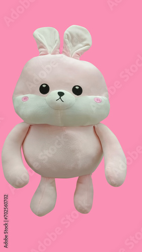 Rabbit toy isolated at pink background. Stuffed puppet animal.