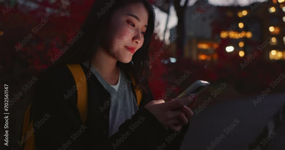 Happy asian woman, phone and night for social media, communication or outdoor networking in city. Female person relax on mobile smartphone in late evening for online chatting in urban town of Japan Happy asian woman, phone and night for social media, communication or outdoor networking in city. Female person relax on mobile smartphone in late evening for online chatting in urban town of Japan