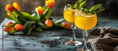 A pair of mimosa cocktails and tulips. photo