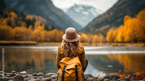 Girl with hat and backpack in nature