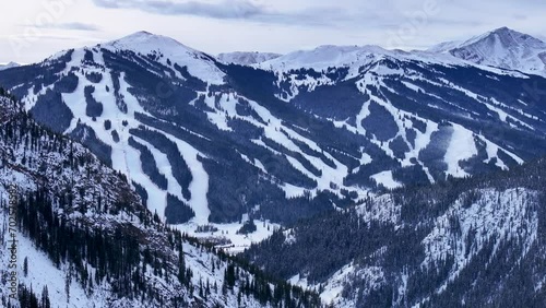 over i70 aerial drone cinematic  Copper Mountain Leadville Colorado Winter December Christmas Ski runs trail Distant landscape Silverthorne Vail Aspen Ten Mile Range cloudy Rocky Mountain circle right photo