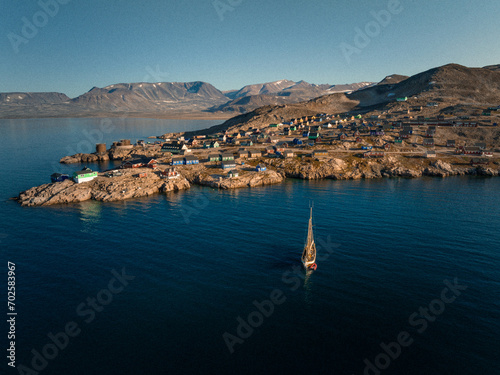 Sunlit Isolation: Aerial View of Ittoqqortoormiit, Greenland's Remote Settlement (ID: 702583967)