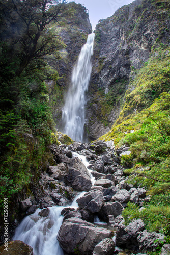 Devils Punchbowl Waterfall is a stunning 131 m waterfall where you can feel the full force and sound of the fresh mountain waterfall from Arthur's Pass National Park New Zealand.  photo
