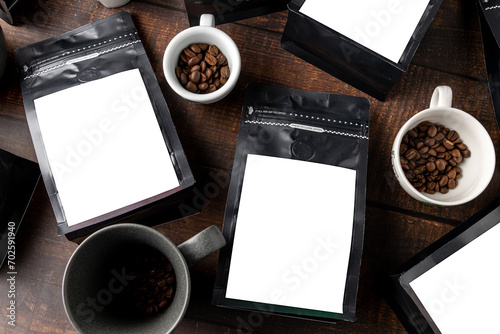 Black coffee foil packaging bag with blank white label on wooden table