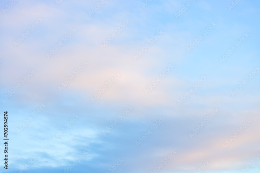 Fototapeta premium A beautiful sky tinted by the sun leaving vibrant shades of gold, pink, blue and multicolored. Clouds in the twilight evening and morning sky. Cloudy sky background in the evening and during the day.