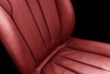 Car red perforated leather interior. Part of leather car seat details. Modern car interior details.