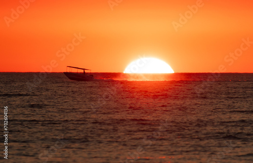 Boat in the sea at sunset