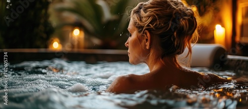 Stunning lady unwinding in a spa jacuzzi. photo