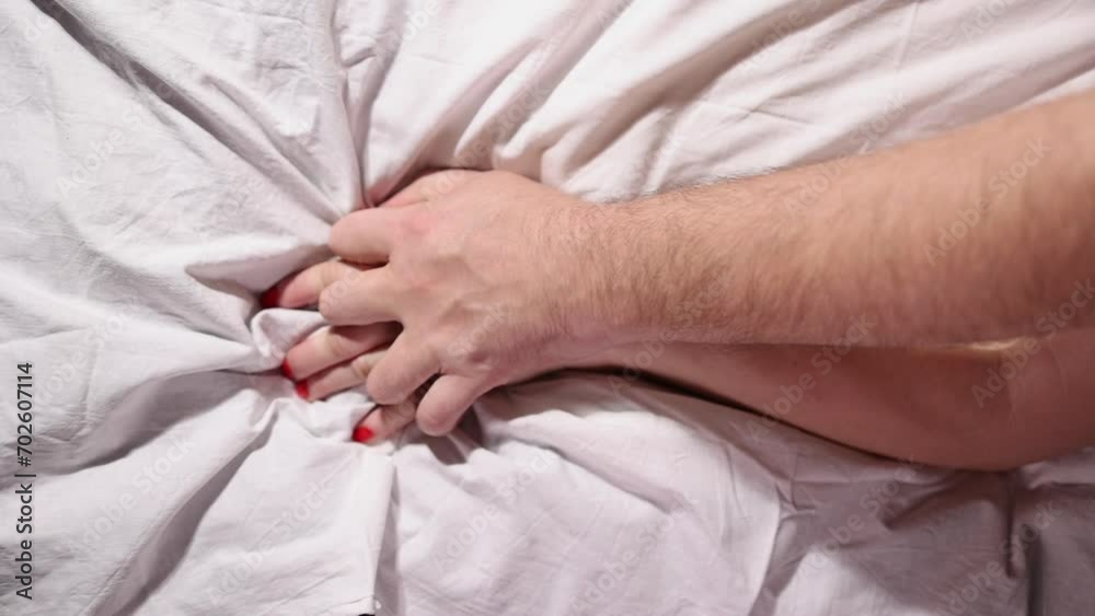Lovers' hands squeeze each other in bed, romantic and passionate lovers make love. High quality FullHD footage Lovers' hands squeeze each other in bed, romantic and passionate lovers make love. High quality FullHD footage