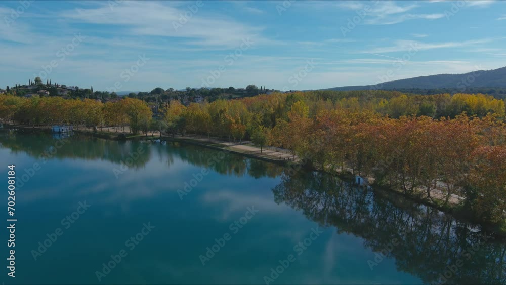 Autumn at Banyoles Lake with blue mirror waters in Girona, Catalonia Autumn at Banyoles Lake with blue mirror waters in Girona, Catalonia