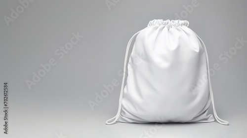 A minimalist white bag can be used to carry items in the photo in front of a gray wall. Generative AI