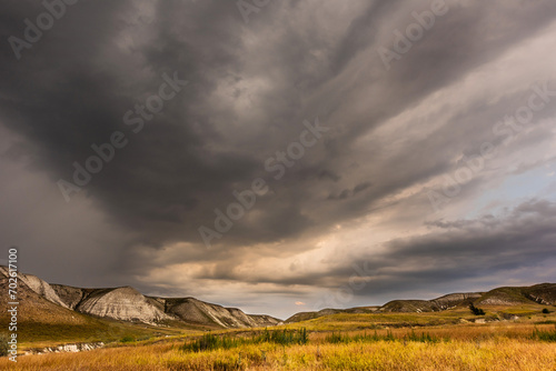 Dark stormy sky. Storm clouds. Dramatic sky over mountain landscape. Rain and hail on the hills. Panorama natural background.  