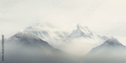 Majestic Mountains Break Through Misty Clouds