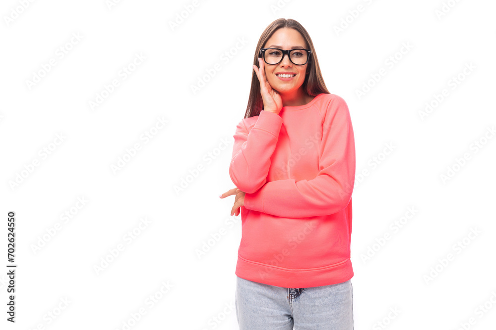 cute happy slim young brunette european woman dressed in pink sweatshirt over isolated background with copy space cute happy slim young brunette european woman dressed in pink sweatshirt over isolated background with copy space