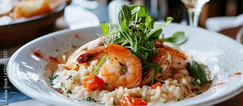 Bright shrimp risotto in a stylish restaurant with beautiful decor.