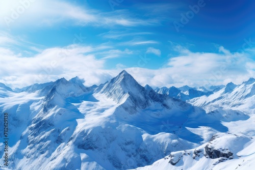 Snow-covered peaks under a clear blue sky in a mountain range