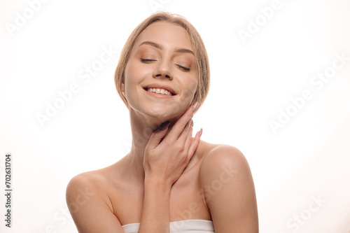 Beauty portrait of a blonde girl posing on an isolated white background. Skin care concept