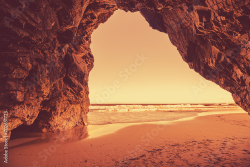 Rocky seascape in the evening. View of the sea from the cave. A golden sunset on the beach. Adraga beach, Lisbon region, Portugal © vvvita