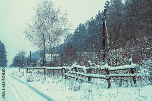 Village in the forest in snowy winter © vvvita