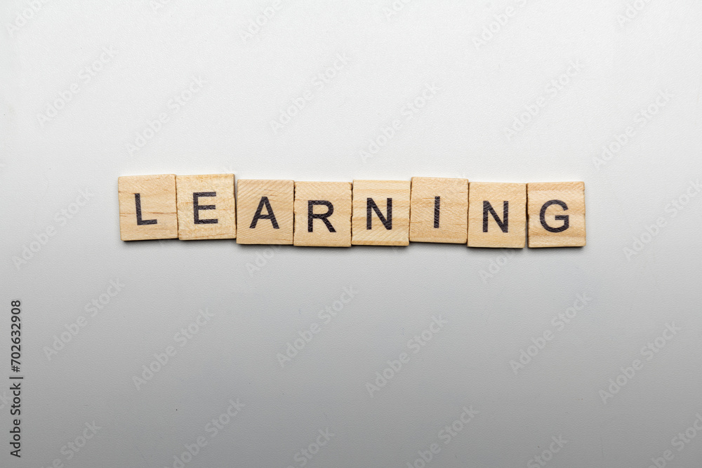 A row of wooden cubes with learning letters A row of wooden cubes with learning letters