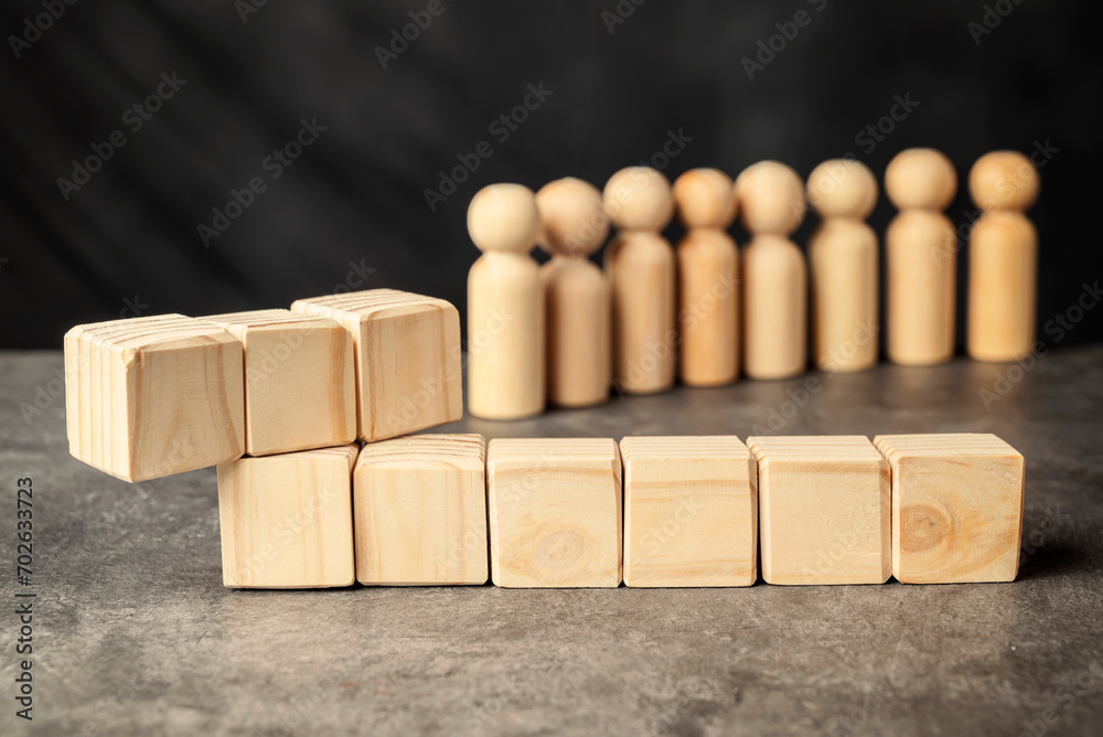 A wooden figure and a row of wooden cubes A wooden figure and a row of wooden cubes