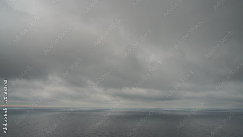 Timelapse rainy Nimbostratus clouds moving in bright sunset sky over stormy sea. Abstract aerial nature summer ocean sunset, sea and sky view. Vacation, travel concept. Weather and Climate Change