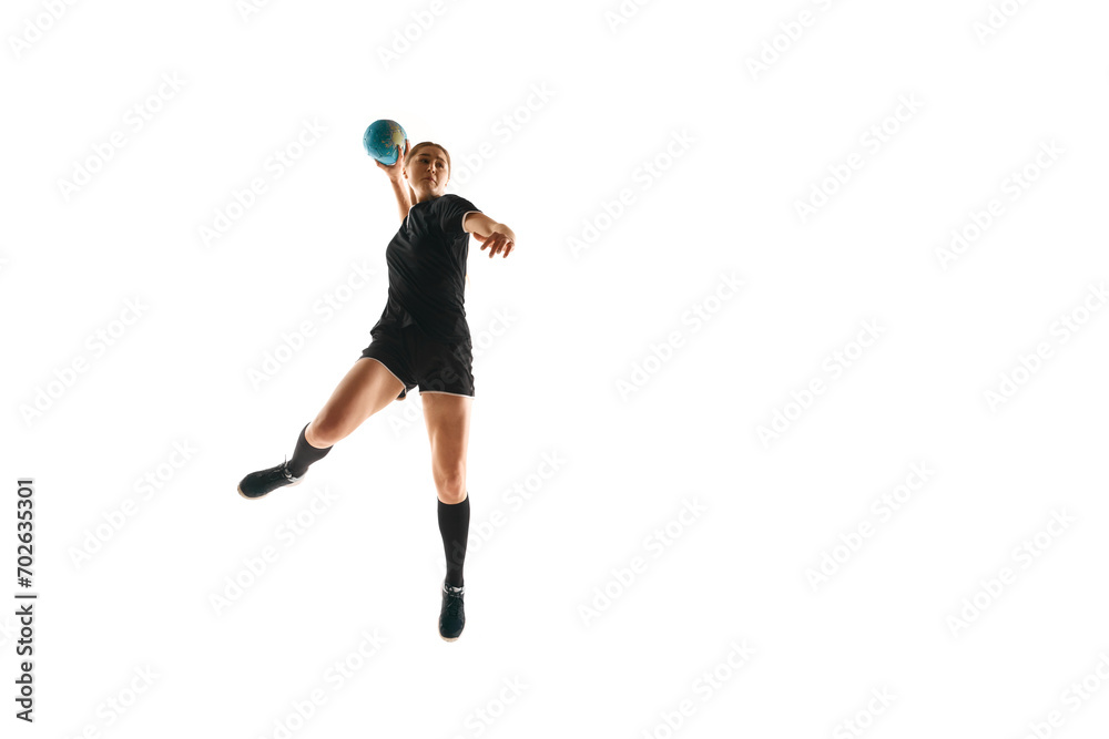 Fit, focused woman engaged in handball drills, displaying determination and focus against white studio background. Concept of sport, hobby, movement, dynamic, active lifestyle, workout, championship.
