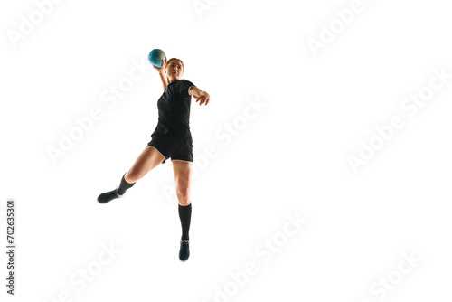 Fototapeta Naklejka Na Ścianę i Meble -  Fit, focused woman engaged in handball drills, displaying determination and focus against white studio background. Concept of sport, hobby, movement, dynamic, active lifestyle, workout, championship.