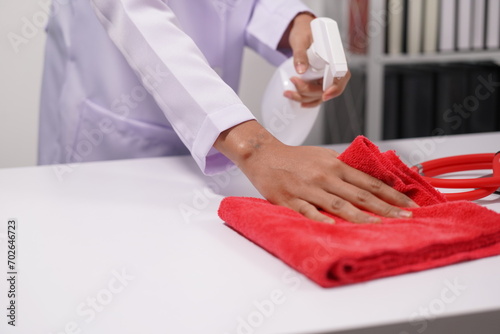 Asian and African female doctor cleaning her desk