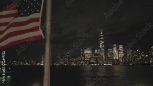 USA flag in night NYC. Memorial Day, Veteran's Day, 4th of July. American Flag Waving near New York City, Manhattan view. Independence Day. Labor, Flag, Patriots, President Day.