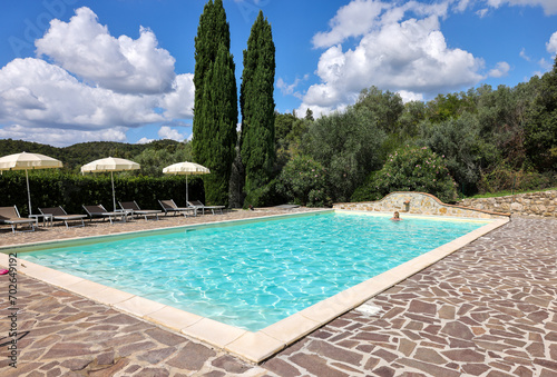 Woman swimming in pool during vacation in Montemassi. Italy