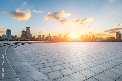 City square floor and Shanghai Bund skyline with modern buildings at sunset