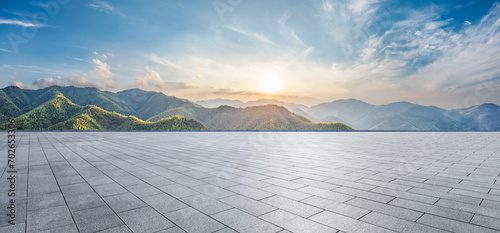 Empty square floor and green mountain with sky clouds at sunset. Panoramic view. photo