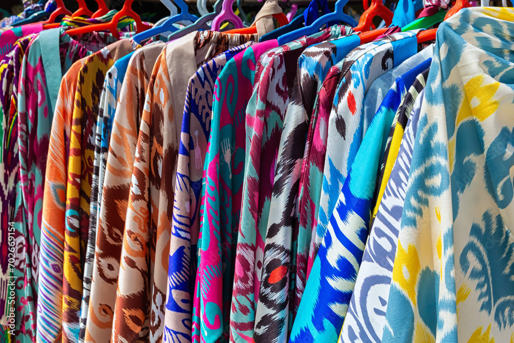 Traditional uzbek multicolored robes (chapan) in souvenir shop. Bukhara (Buxoro), Uzbekistan