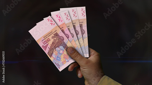 West African CFA Franc growing pile of money in hand concept 3d illustration photo